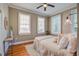 Bright bedroom with natural light, neutral color palette, hardwood floors, and a ceiling fan at 22 Ashton St, Charleston, SC 29403