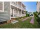 Charming two-story home with a brick driveway and a spacious front yard with mature landscaping at 22 Ashton St, Charleston, SC 29403