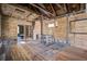 Renovation project showcasing the exposed structure with a brick fireplace, and bathed in natural light at 22 Ashton St, Charleston, SC 29403