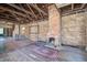 Unfinished living room with exposed beams, brick fireplace, and unfinished walls showing great potential at 22 Ashton St, Charleston, SC 29403