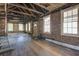 Large living room featuring exposed beams and plenty of windows offering natural light and potential at 22 Ashton St, Charleston, SC 29403