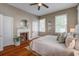 Comfortable bedroom with hardwood floors, white bedding, and decorative fireplace adding charm to the space at 22 Ashton St, Charleston, SC 29403