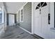 Inviting front porch with seating, offering a relaxing outdoor space with a rocking chair and neutral tones at 22 Ashton St, Charleston, SC 29403
