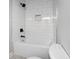 Modern bathroom featuring a bathtub with sleek subway tile surround and modern black fixtures at 222 New Iris Ln, Ridgeville, SC 29472