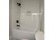 Modern bathtub with white subway tile, black shower head, and a built-in shelf at 222 New Iris Ln, Ridgeville, SC 29472