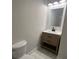 Bathroom featuring wood vanity, modern sink, faucet, mirror, and lighting at 222 New Iris Ln, Ridgeville, SC 29472