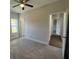 Carpeted bedroom features neutral walls, ceiling fan, and two doorways at 222 New Iris Ln, Ridgeville, SC 29472