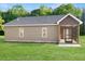 Beautiful home exterior with a screened-in porch and lush green lawn at 222 New Iris Ln, Ridgeville, SC 29472