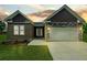 Charming single-story home with stone accents and well-manicured lawn at 222 New Iris Ln, Ridgeville, SC 29472