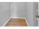 Walk-in closet showcasing ample shelving and wood-look flooring at 2221 Chatelain Way, Mount Pleasant, SC 29464