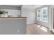 Bright dining area with modern lighting, adjacent kitchen, and natural light from large windows at 2221 Chatelain Way, Mount Pleasant, SC 29464