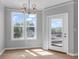 Dining area featuring modern lighting, large windows, and access to outdoor deck at 2221 Chatelain Way, Mount Pleasant, SC 29464