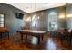 Stylish game room with a classic billiard table, bar-height seating, and hardwood floors, perfect for entertaining at 2221 Chatelain Way, Mount Pleasant, SC 29464