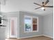 Bright living room featuring large windows and a ceiling fan at 2221 Chatelain Way, Mount Pleasant, SC 29464