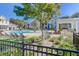 Beautifully landscaped community pool area with lush greenery, palm trees, and comfortable seating for residents at 2221 Chatelain Way, Mount Pleasant, SC 29464