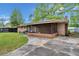 A brick house with a screened-in porch and a well-maintained green lawn at 223 Dandridge Rd, Walterboro, SC 29488