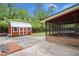 Backyard area featuring a storage shed, a screened in porch, and a concrete patio at 223 Dandridge Rd, Walterboro, SC 29488
