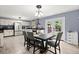 Light-filled dining area next to the kitchen with gray chairs and table set for a meal at 223 Dandridge Rd, Walterboro, SC 29488