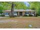 Charming brick home featuring a double-door entry and a covered front porch swing at 223 Dandridge Rd, Walterboro, SC 29488