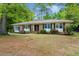 Charming brick home featuring a double-door entry and a covered front porch swing at 223 Dandridge Rd, Walterboro, SC 29488