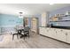 Bright kitchen with laminate floors, black counters, and a view of the dining area at 223 Dandridge Rd, Walterboro, SC 29488