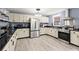 Bright kitchen with stainless steel appliances, black countertops, and ample cabinetry at 223 Dandridge Rd, Walterboro, SC 29488