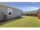 Green backyard features a wood fence, grassy lawn and screened in porch at 223 Goshen Rd, Moncks Corner, SC 29461