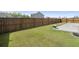 Spacious backyard featuring a green lawn with wood fence for privacy and a concrete patio for outdoor activities at 223 Goshen Rd, Moncks Corner, SC 29461