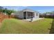 Fenced backyard with green grass, patio, and a screened-in porch that provides outdoor relaxation at 223 Goshen Rd, Moncks Corner, SC 29461