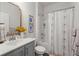 A well decorated bathroom featuring a vanity with sink, decorative mirror and shower-tub combo at 223 Goshen Rd, Moncks Corner, SC 29461