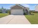 View of the exterior with a long driveway leading to the two car garage at 223 Goshen Rd, Moncks Corner, SC 29461