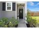 Inviting front door with gray siding, decorative wreath, and manicured landscaping at 223 Goshen Rd, Moncks Corner, SC 29461