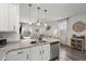 Kitchen featuring white cabinets, stainless appliances, and an open view into the living room at 223 Goshen Rd, Moncks Corner, SC 29461