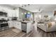 Open concept kitchen with white cabinets, stainless appliances, and view into the living room at 223 Goshen Rd, Moncks Corner, SC 29461
