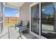 Screened patio with two chairs and a sliding glass door to the home interior at 223 Goshen Rd, Moncks Corner, SC 29461