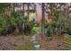 Lush backyard with stone path leading to a spacious home and outdoor deck at 2242 Terrabrook Ln, Charleston, SC 29412