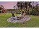 Backyard with a stone patio featuring an outdoor fire pit and seating at 2242 Terrabrook Ln, Charleston, SC 29412