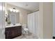 Bathroom featuring a dark wood vanity with a white sink, and a toilet near a white shower curtain at 2242 Terrabrook Ln, Charleston, SC 29412