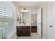 Bright bathroom with a dark wood vanity, large mirror, and natural light from a window with blinds at 2242 Terrabrook Ln, Charleston, SC 29412