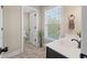Bathroom with a light-colored wall, a white sink, a dark wood vanity, and a large window at 2242 Terrabrook Ln, Charleston, SC 29412