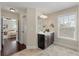 Well-appointed bathroom with a dark vanity, mirror, and natural light from a window at 2242 Terrabrook Ln, Charleston, SC 29412