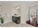 Bathroom with a dark wood vanity, large mirror, decorative lighting, and access to the bedroom at 2242 Terrabrook Ln, Charleston, SC 29412