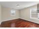 Empty room with hardwood flooring and two windows bringing in light at 2242 Terrabrook Ln, Charleston, SC 29412