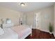 Bedroom featuring hardwood floors, a white dresser, and a white bed with a pink accent blanket at 2242 Terrabrook Ln, Charleston, SC 29412