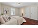 Bedroom with hardwood floors, a white bed, and a window overlooking the outdoors at 2242 Terrabrook Ln, Charleston, SC 29412