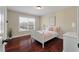 Cozy bedroom with a white-painted bed, plush pillows, and natural light streaming through a window at 2242 Terrabrook Ln, Charleston, SC 29412