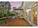 Spacious wooden deck with cable railing, offering scenic views of the landscaped backyard at 2242 Terrabrook Ln, Charleston, SC 29412