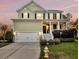 Charming two-story home with a well-manicured lawn, a covered porch and attached garage at 2242 Terrabrook Ln, Charleston, SC 29412