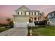 Charming two-story home with a welcoming front porch, manicured lawn, and attached two-car garage at 2242 Terrabrook Ln, Charleston, SC 29412
