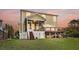Exterior view of the home featuring a screened porch, a deck, and a spacious backyard at 2242 Terrabrook Ln, Charleston, SC 29412